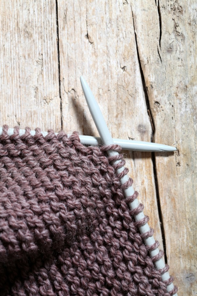 Knitting in progress on a wooden floor